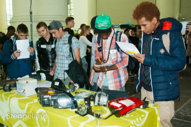 Group of boys show interest in metal instrument parts